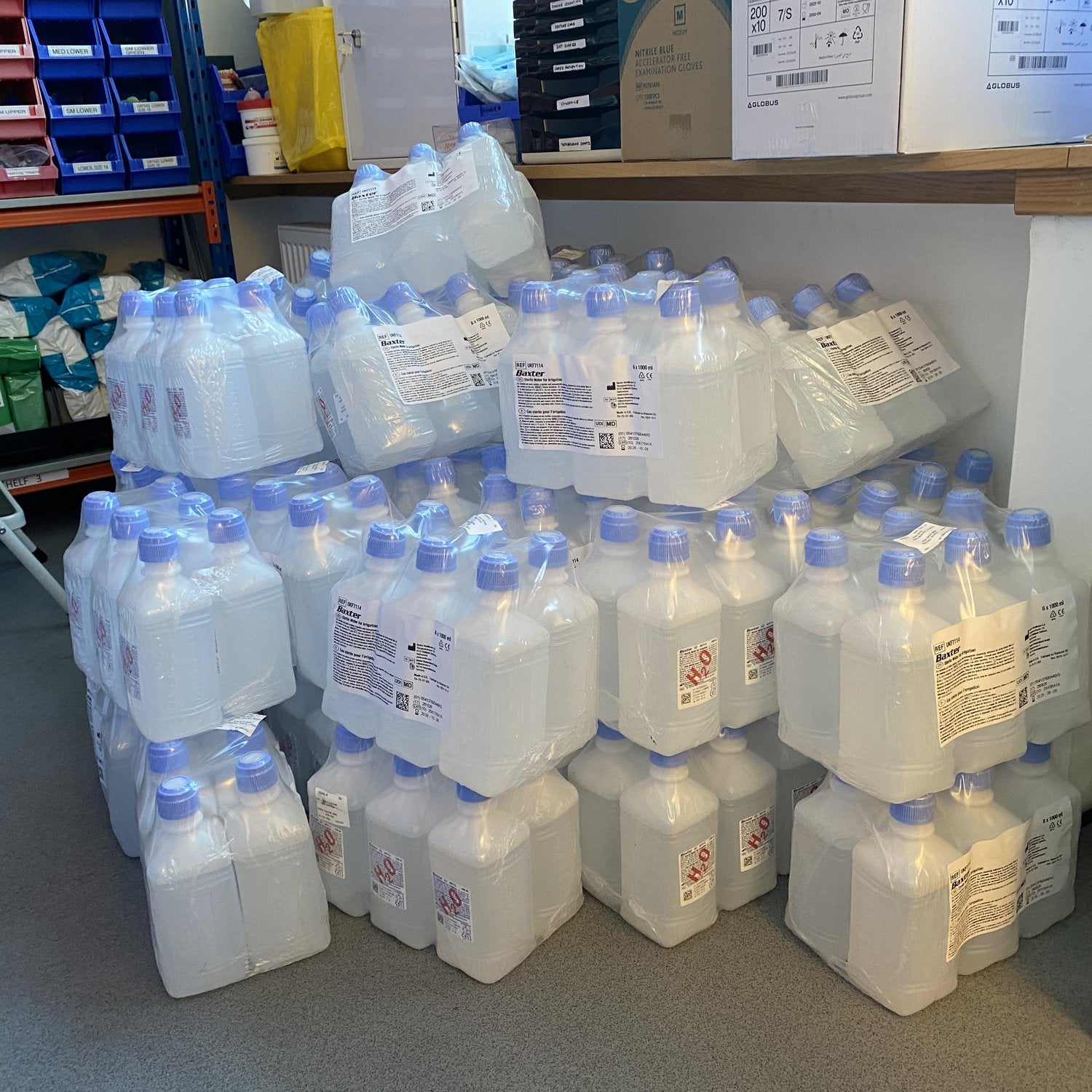 Stockpile of bottled sterile water for the autoclaves in a store room