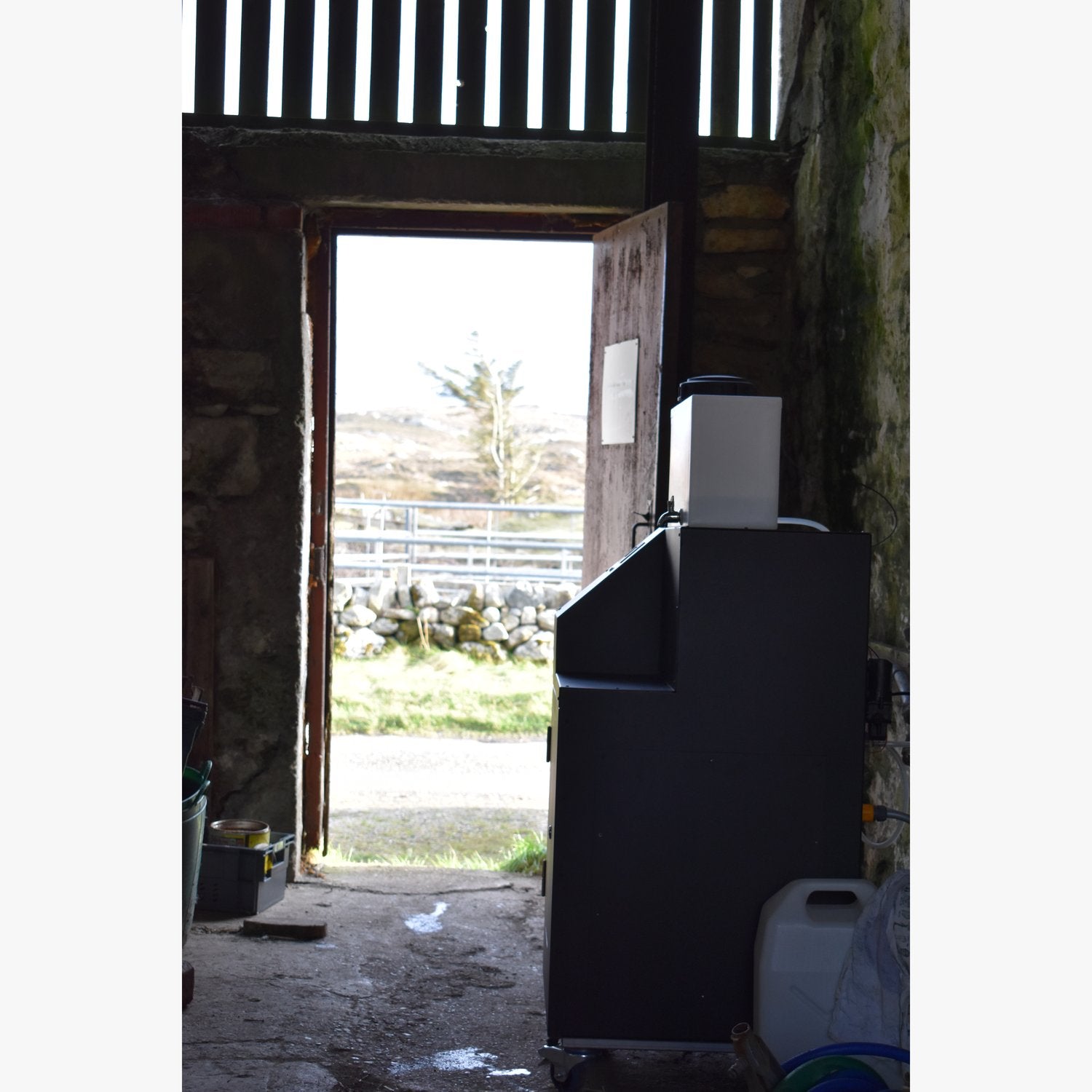 WaterOne in the farm barn doorway with the Hebridean landscape beyond