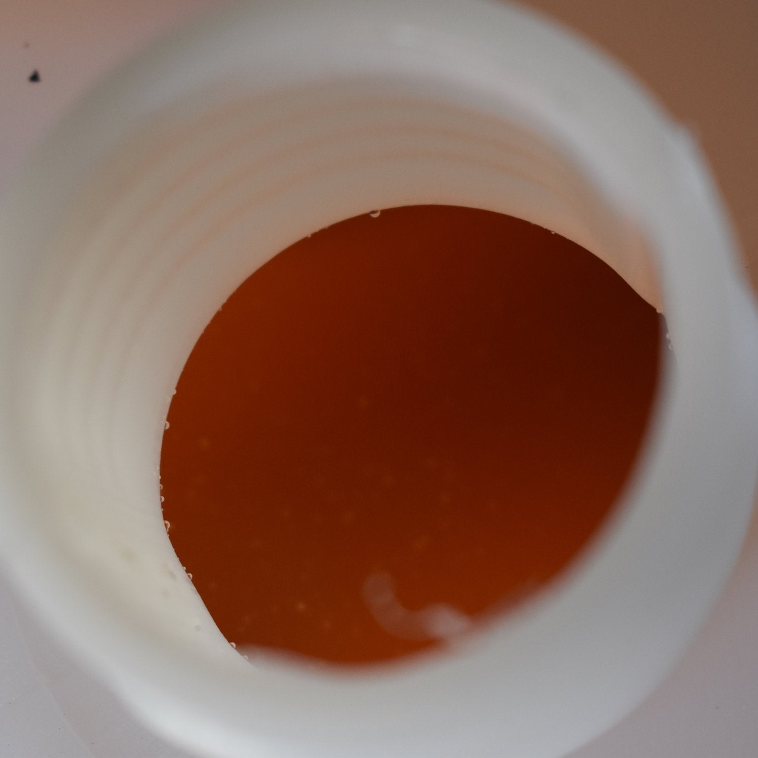 Close-up of orange-brown untreated private water supply in a jerrycan