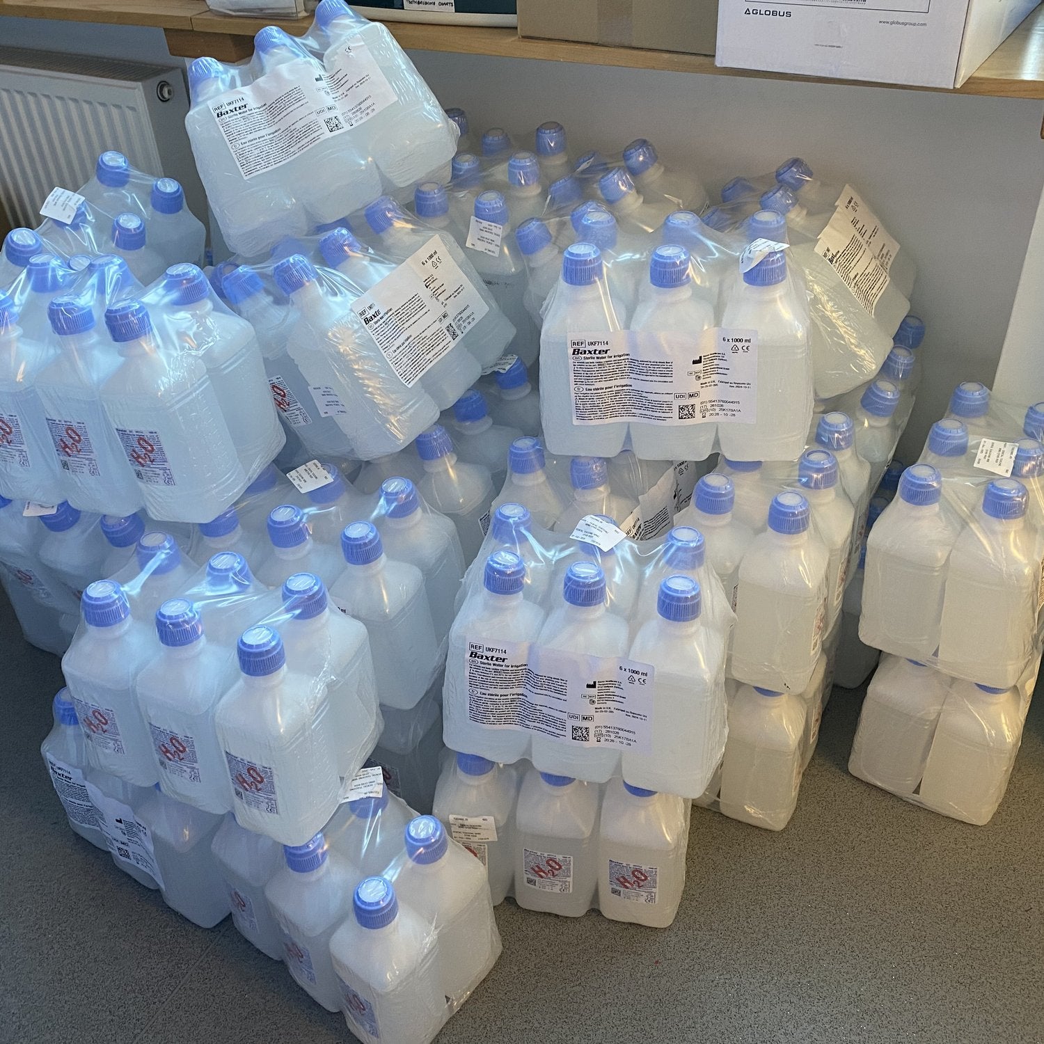 Pile of single-use plastic bottles of sterile water